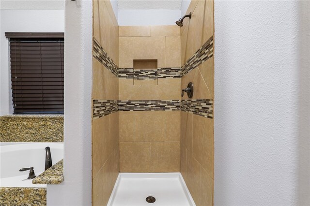 bathroom with shower with separate bathtub