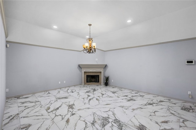 unfurnished living room featuring a tiled fireplace and an inviting chandelier