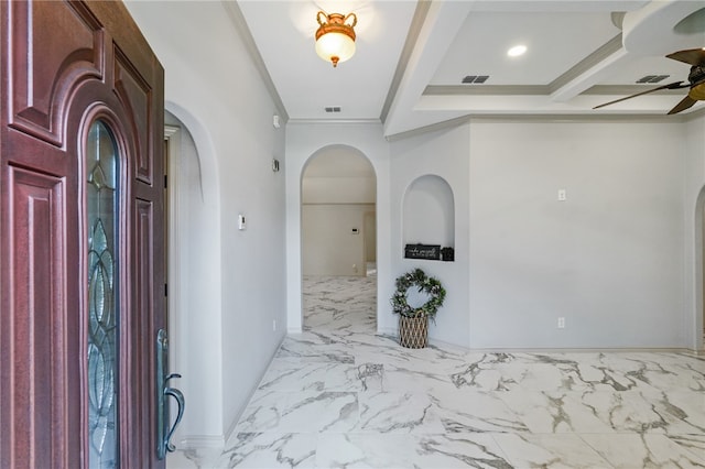 foyer with ornamental molding, beamed ceiling, and ceiling fan