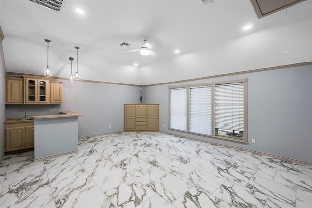 interior space featuring pendant lighting, light brown cabinets, vaulted ceiling, and crown molding