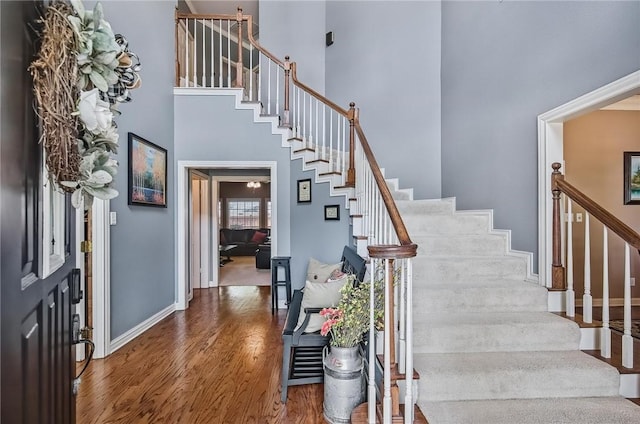 5918 Woodmere Dr, Corpus Christi, TX 78414 - foyer with stairway, wood finished floors, a high ceiling, and baseboards