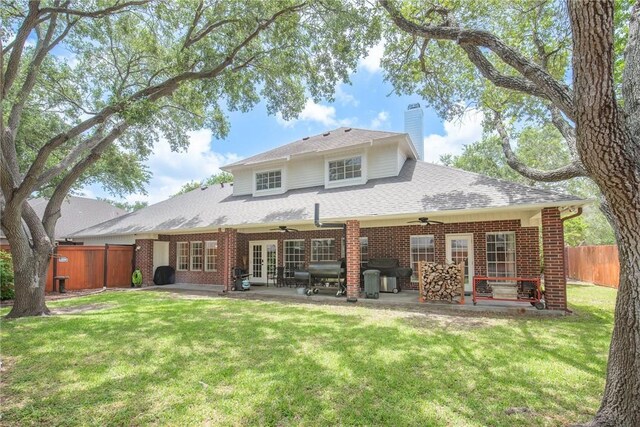 5918 Woodmere Dr, Corpus Christi, TX 78414 - back of property featuring ceiling fan, french doors, a patio area, a chimney, and brick siding