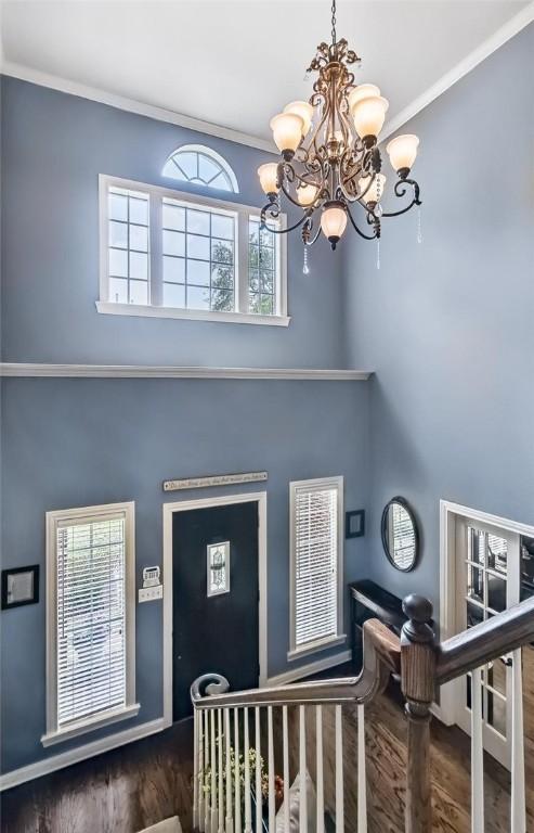 5918 Woodmere Dr, Corpus Christi, TX 78414 - foyer entrance with a chandelier, wood finished floors, crown molding, and a towering ceiling