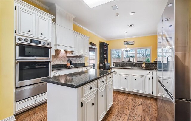 5918 Woodmere Dr, Corpus Christi, TX 78414 - kitchen featuring stainless steel appliances, a sink, a warming drawer, white cabinetry, and crown molding