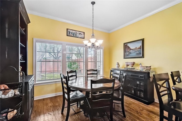 5918 Woodmere Dr, Corpus Christi, TX 78414 - dining area featuring a chandelier, baseboards, dark wood-style flooring, and ornamental molding