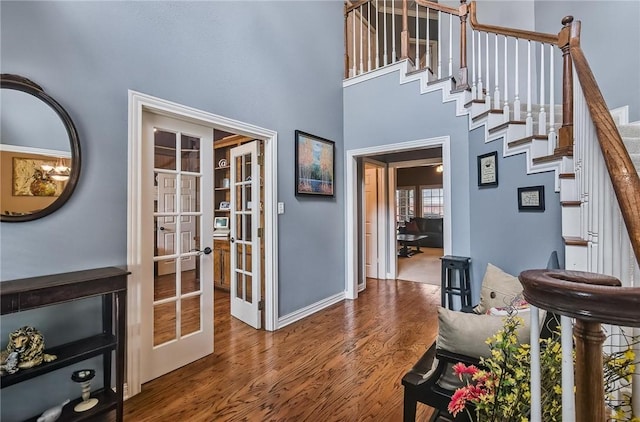 5918 Woodmere Dr, Corpus Christi, TX 78414 - entrance foyer featuring french doors, wood finished floors, stairway, a towering ceiling, and baseboards