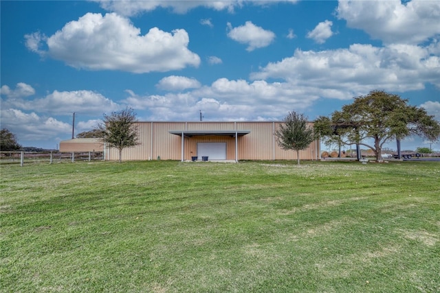 view of yard featuring a garage and an outdoor structure