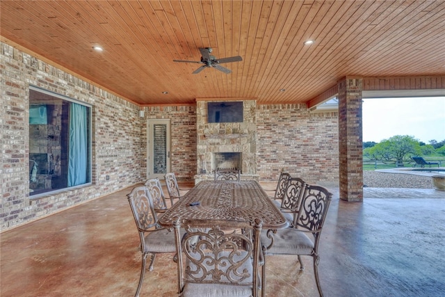 view of patio / terrace featuring an outdoor stone fireplace and ceiling fan