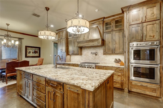 kitchen featuring decorative light fixtures, custom range hood, a center island with sink, and stainless steel appliances