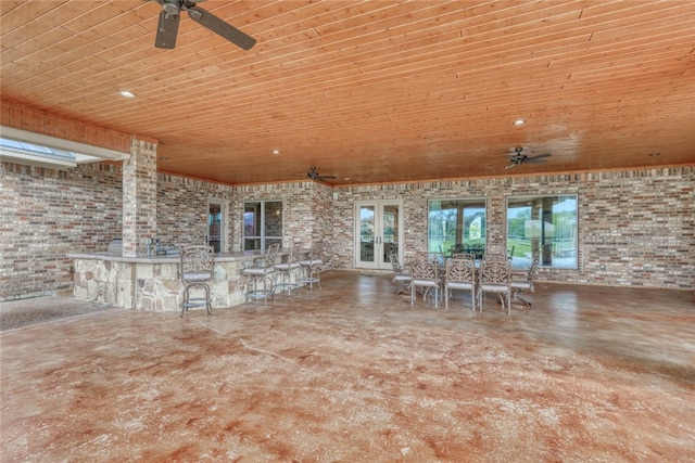 view of patio with exterior bar, french doors, and ceiling fan