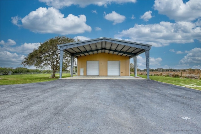 view of parking / parking lot with a lawn and a garage