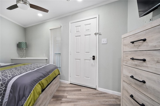 bedroom with ceiling fan, light wood-type flooring, and ornamental molding