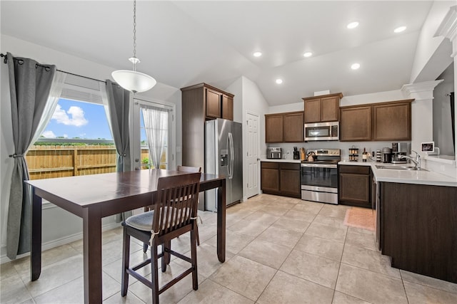 6734 Mikayla St, Corpus Christi, TX 78413 - kitchen featuring stainless steel appliances, vaulted ceiling, light countertops, light tile patterned floors, and pendant lighting