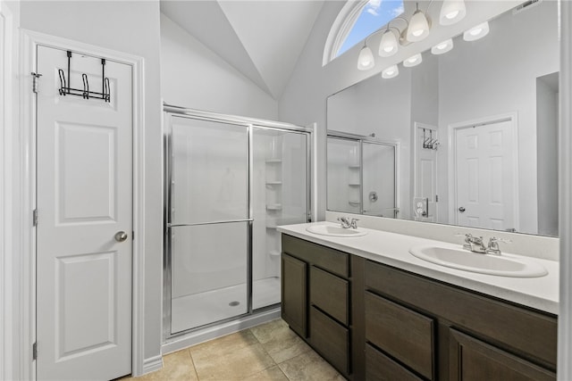6734 Mikayla St, Corpus Christi, TX 78413 - bathroom featuring vaulted ceiling, a shower stall, double vanity, and tile patterned flooring