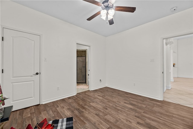 empty room with hardwood / wood-style floors and ceiling fan