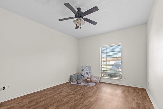 spare room with hardwood / wood-style flooring and ceiling fan