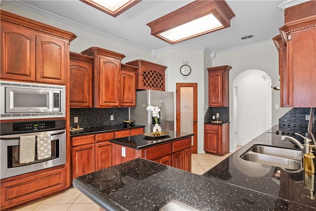 kitchen featuring appliances with stainless steel finishes, tasteful backsplash, crown molding, sink, and light tile patterned flooring