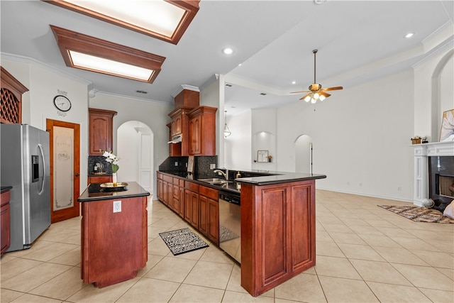 kitchen featuring appliances with stainless steel finishes, tasteful backsplash, ornamental molding, ceiling fan, and a kitchen island