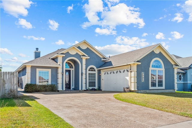 ranch-style house with a front lawn and a garage