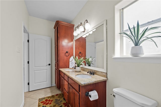 bathroom with tile patterned flooring, vanity, and toilet