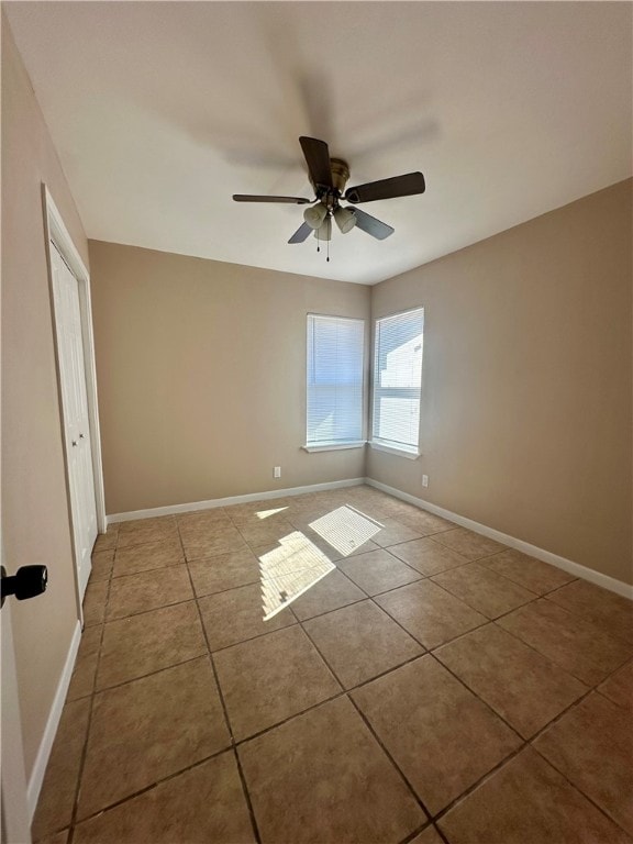 unfurnished bedroom featuring ceiling fan and light tile patterned floors