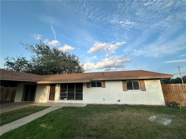 back of house featuring a yard