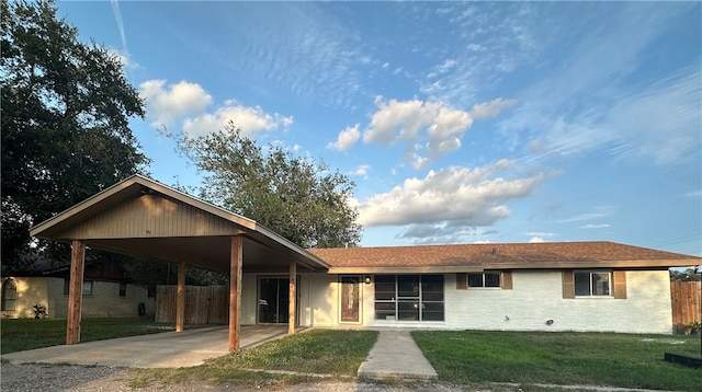 rear view of house with a yard and a carport