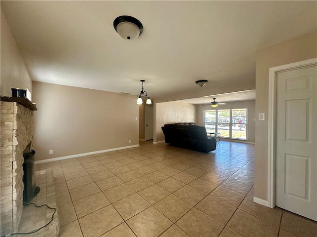 unfurnished living room featuring ceiling fan and light tile patterned flooring