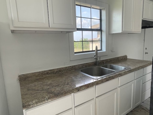 kitchen featuring white cabinets, plenty of natural light, and sink