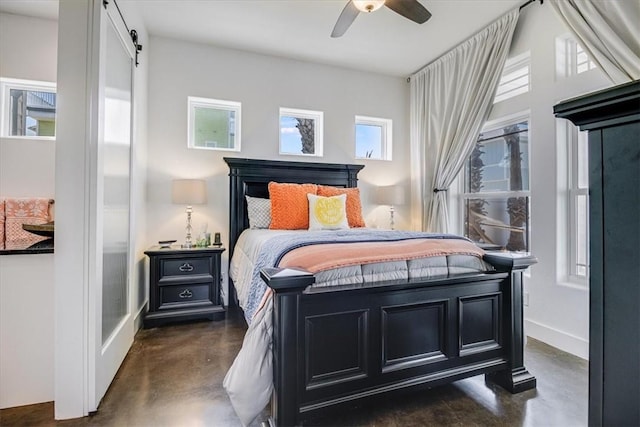 602 Banyan Beach Dr, Port Aransas, TX 78373 - bedroom featuring concrete floors, a barn door, and ceiling fan