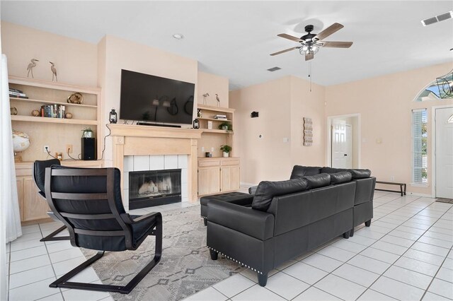 1025 Pompano Dr, Aransas Pass, TX 78336 - living area with light tile patterned flooring, a fireplace, and ceiling fan