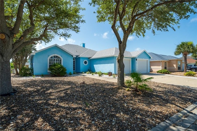 1025 Pompano Dr, Aransas Pass, TX 78336 - ranch-style home with an attached garage, driveway, and stucco siding