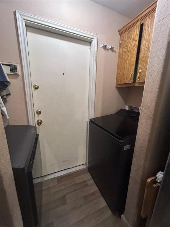 laundry area with cabinets and dark hardwood / wood-style floors