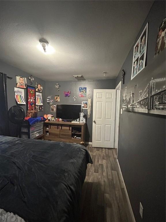 bedroom with wood-type flooring