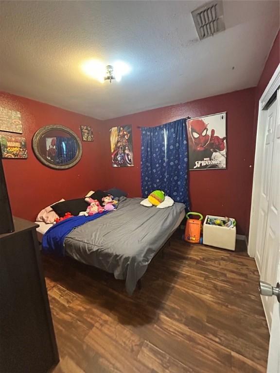 bedroom with hardwood / wood-style flooring