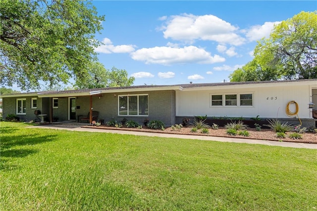 single story home with brick siding and a front yard