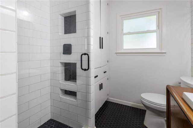 full bathroom featuring tile patterned flooring, a shower stall, toilet, and vanity