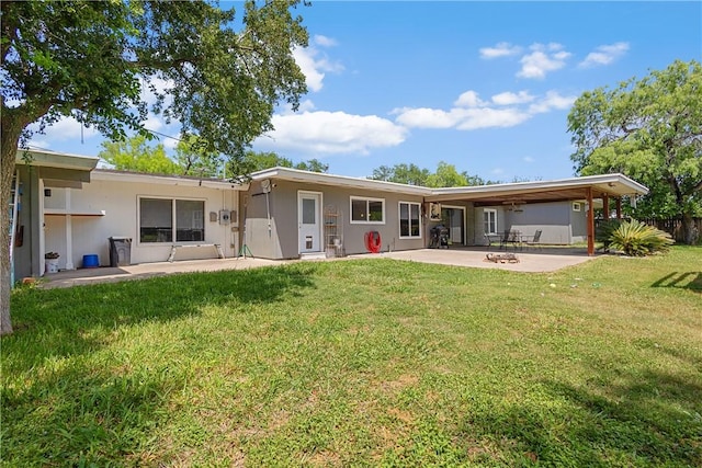 back of house featuring a yard, fence, a patio area, and stucco siding