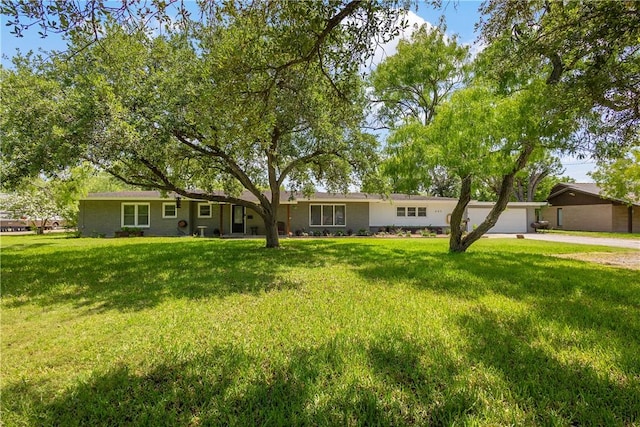 ranch-style home with an attached garage, driveway, and a front lawn