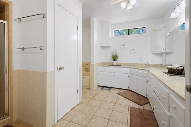 kitchen featuring white cabinets, a sink, light countertops, and light tile patterned floors