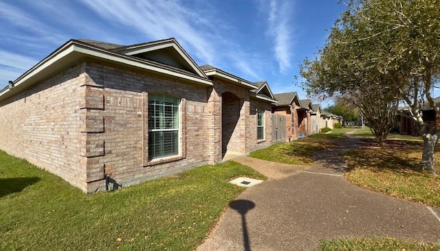 view of property exterior featuring a lawn