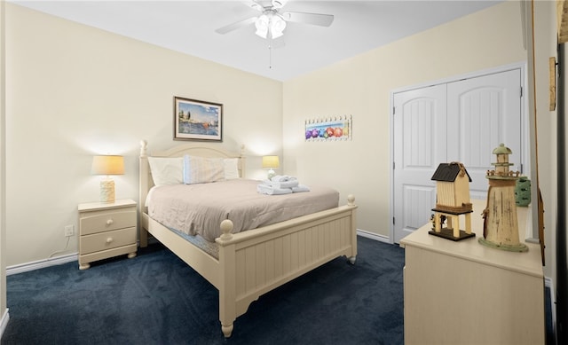 bedroom with ceiling fan, a closet, and dark carpet