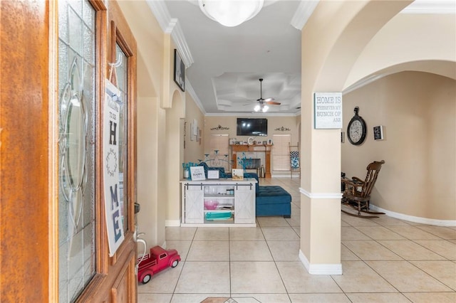 6814 Boardwalk Ave, Corpus Christi, TX 78414 - hallway with ornamental molding, arched walkways, light tile patterned floors, a raised ceiling, and baseboards