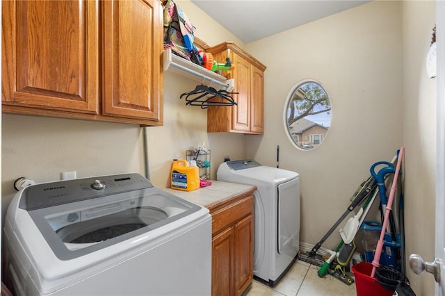 6814 Boardwalk Ave, Corpus Christi, TX 78414 - washroom with cabinet space, washer and dryer, and light tile patterned floors
