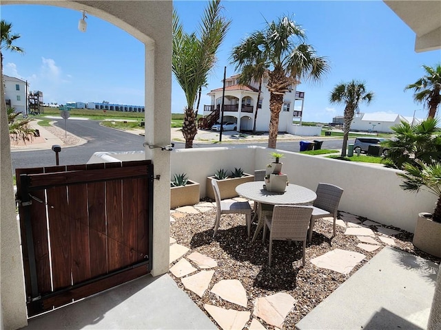 view of patio with fence and a gate