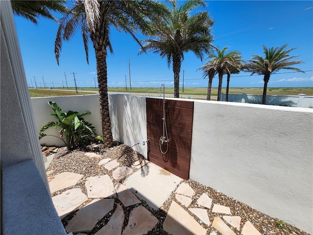 exterior space featuring a water view, a gate, and fence