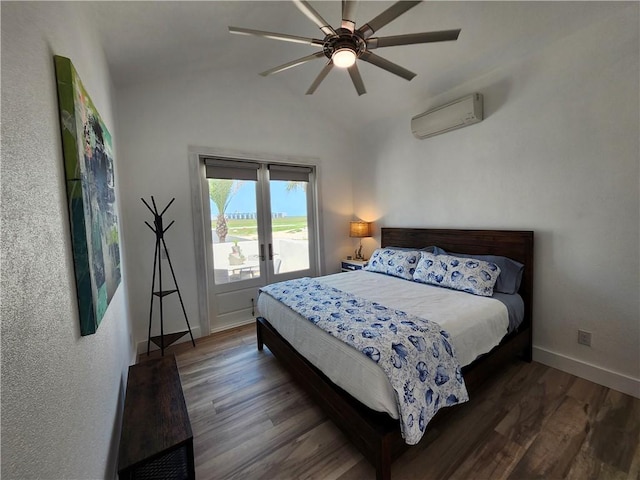 bedroom with lofted ceiling, access to outside, wood finished floors, and a wall mounted air conditioner