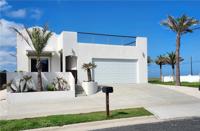 modern home featuring concrete driveway and stucco siding