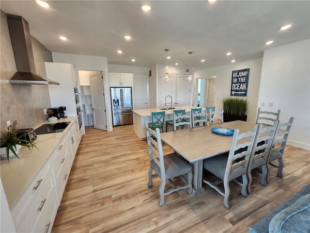 dining room featuring recessed lighting and light wood finished floors