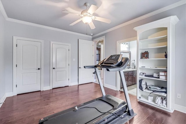 workout room featuring built in features, baseboards, dark wood-style flooring, ornamental molding, and ceiling fan